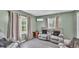 Comfortable living room features neutral-toned walls, tile flooring, and plush reclining sofa at 326 Sunset Rd, Frostproof, FL 33843