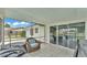 This is a screened-in patio with sliding glass doors that open to the backyard and pool at 326 Sunset Rd, Frostproof, FL 33843