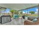 This is a screened-in patio with wicker furniture and a view of the pool at 326 Sunset Rd, Frostproof, FL 33843