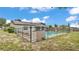 Backyard pool with solar panels features a secure fence and lounge chairs at 326 Sunset Rd, Frostproof, FL 33843