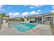 Backyard pool features a screened-in lanai, lounge chairs, and a secure fence at 326 Sunset Rd, Frostproof, FL 33843
