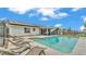 Backyard pool with solar panels features a screened-in lanai, and lounge chairs at 326 Sunset Rd, Frostproof, FL 33843