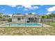 Backyard pool with solar panels features a secure fence at 326 Sunset Rd, Frostproof, FL 33843
