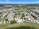 Aerial view of community highlighting the home's location near community pool, pond, and green spaces at 348 Lake Suzanne Dr, Lake Wales, FL 33859