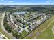 Expansive aerial view showcasing the neighborhood's well-maintained homes and a picturesque lake at 348 Lake Suzanne Dr, Lake Wales, FL 33859