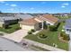 Aerial view showing a well-kept home with manicured lawn, paver driveway, and lush landscaping at 348 Lake Suzanne Dr, Lake Wales, FL 33859