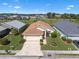 Aerial shot showcases a well-maintained home with a paver driveway and lush landscaping at 348 Lake Suzanne Dr, Lake Wales, FL 33859