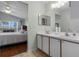 This bathroom features a double vanity, ample lighting, and seamless access to the adjacent bedroom at 348 Lake Suzanne Dr, Lake Wales, FL 33859