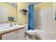 Well-lit bathroom with vanity sink, toilet, and bathtub/shower combination at 348 Lake Suzanne Dr, Lake Wales, FL 33859