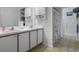 Bright bathroom with double vanity, tile floors, and shower with a sailboat-themed curtain at 348 Lake Suzanne Dr, Lake Wales, FL 33859