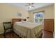 Bedroom with a queen bed, ceiling fan, and a bright window view at 348 Lake Suzanne Dr, Lake Wales, FL 33859