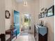 Bright foyer featuring tile flooring, blue front door, and stylish decor at 348 Lake Suzanne Dr, Lake Wales, FL 33859