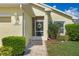 Inviting front door with charming wreath detail and manicured landscaping at 348 Lake Suzanne Dr, Lake Wales, FL 33859