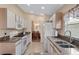 Functional kitchen featuring stone countertops and white appliances at 348 Lake Suzanne Dr, Lake Wales, FL 33859
