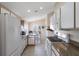 Bright kitchen features white appliances, granite countertops, and a breakfast nook bathed in natural light at 348 Lake Suzanne Dr, Lake Wales, FL 33859