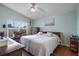 Light-filled main bedroom features wood floors, a ceiling fan, and a spacious layout at 348 Lake Suzanne Dr, Lake Wales, FL 33859