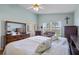 Light-filled main bedroom with ceiling fan, wood floors, and a spacious layout at 348 Lake Suzanne Dr, Lake Wales, FL 33859