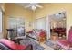 Comfortable sunroom featuring a sleeper sofa, treadmill, and seamless access to the living room at 348 Lake Suzanne Dr, Lake Wales, FL 33859