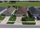 Aerial view of the home showcasing the lawn, roof, driveway, and surrounding neighborhood at 373 St Georges Cir, Eagle Lake, FL 33839