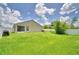 Exterior view of the home's backyard with white fencing and an enclosed patio at 373 St Georges Cir, Eagle Lake, FL 33839