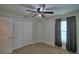 Bedroom featuring carpet, a ceiling fan, and a closet at 373 St Georges Cir, Eagle Lake, FL 33839