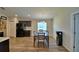Open-concept dining area with wood floors, a modern light fixture, and views of the kitchen at 373 St Georges Cir, Eagle Lake, FL 33839