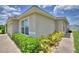 Corner view of the property featuring a well-maintained garden and pathway at 373 St Georges Cir, Eagle Lake, FL 33839