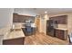 Well-lit kitchen featuring modern appliances, laminate countertops, and wood-look floors at 373 St Georges Cir, Eagle Lake, FL 33839
