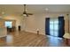 Bright living room featuring wood floors, a ceiling fan, and access to the outdoor patio at 373 St Georges Cir, Eagle Lake, FL 33839