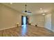 Inviting living area with wood-look floors, ceiling fan, and ample natural light at 373 St Georges Cir, Eagle Lake, FL 33839
