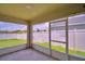 Enclosed patio with a concrete floor with large windows overlooking the backyard at 373 St Georges Cir, Eagle Lake, FL 33839