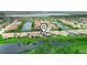 Expansive aerial view of a community with a lake, water features, and well-maintained landscaping at 3802 Litchfield Loop, Lake Wales, FL 33859