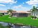 Aerial view of backyard with screened lanai, well-maintained lawn and water view at 3802 Litchfield Loop, Lake Wales, FL 33859