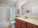 Bathroom with vanity, mirror, shower and tub combo with a blue coral shower curtain at 3802 Litchfield Loop, Lake Wales, FL 33859
