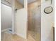 Walk-in shower in bathroom featuring tiled walls, a glass door, and neutral accents at 3802 Litchfield Loop, Lake Wales, FL 33859
