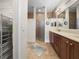 Bathroom with dual vanity, wood cabinets, a walk-in shower, and a neutral color scheme at 3802 Litchfield Loop, Lake Wales, FL 33859