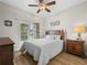 Inviting bedroom with a wooden bed frame, soft lighting, and a view of the outdoors at 3802 Litchfield Loop, Lake Wales, FL 33859