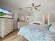 Well-lit bedroom featuring hardwood floors, a ceiling fan, and a spacious layout at 3802 Litchfield Loop, Lake Wales, FL 33859