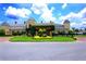 Stunning clubhouse exterior with lush landscaping, circular driveway, and covered entrance at 3802 Litchfield Loop, Lake Wales, FL 33859