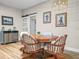 Cozy dining room featuring wood table, chandelier, wood floors, and slider door at 3802 Litchfield Loop, Lake Wales, FL 33859