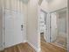 Hallway with access to the front door, bedroom, and bathroom, all enhanced by stylish wood flooring at 3802 Litchfield Loop, Lake Wales, FL 33859