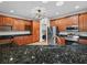 Well-appointed kitchen boasts dark granite countertops, stainless steel appliances, and custom cabinetry for modern convenience at 3802 Litchfield Loop, Lake Wales, FL 33859