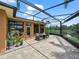 Screened-in lanai with brick-patterned pavers, comfortable seating and a view of the lake at 3802 Litchfield Loop, Lake Wales, FL 33859