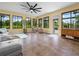 Bright living room with tile flooring, a modern fan, and large windows offering scenic views at 3802 Litchfield Loop, Lake Wales, FL 33859
