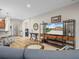 Bright living area with an open floor plan showcases sleek furniture and transitions to kitchen and office nook at 3802 Litchfield Loop, Lake Wales, FL 33859