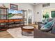 Comfortable living room with entertainment center, circular coffee table, and views to the bedroom and lanai at 3802 Litchfield Loop, Lake Wales, FL 33859