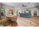 Spacious living space featuring an open concept design with wood floors, dining area, living room, and kitchen at 3802 Litchfield Loop, Lake Wales, FL 33859