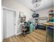 Bright storage room featuring wood-look floors, stainless worktable, mini fridge and metal shelving at 3802 Litchfield Loop, Lake Wales, FL 33859