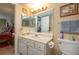 Clean bathroom with a vanity, large mirror, and ample lighting next to the main bedroom at 400 El Camino Dr # 201, Winter Haven, FL 33884