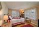 Cozy bedroom featuring a comfortable bed with decorative quilt, side tables, and ample natural light at 400 El Camino Dr # 201, Winter Haven, FL 33884